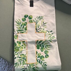 White T-Shirt with Green Leaf Cross Design